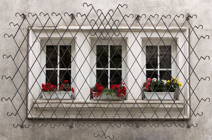 Gesmede bars voor de ramen: decoratie en betrouwbare bescherming van het huis